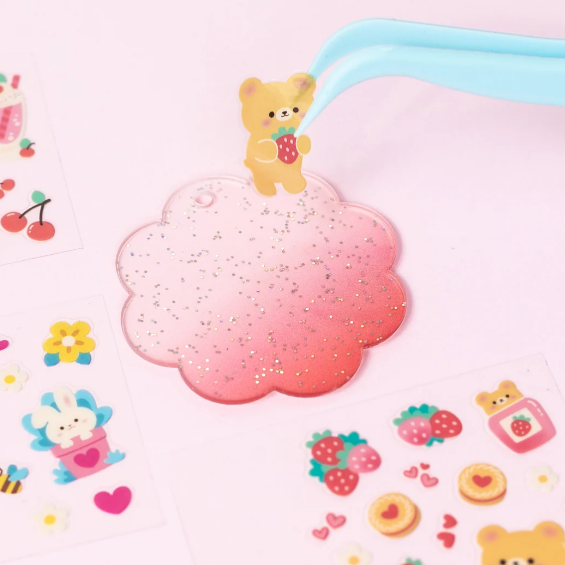 Cute cartoon bear character on a pink cloud with various small illustrations on a light pink background
