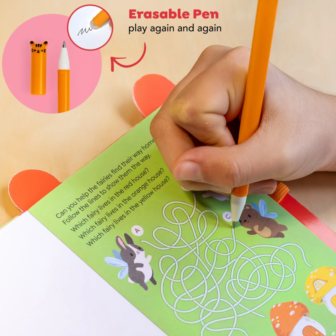 A hand uses an orange erasable pen to write on a colorful children's activity book. The image includes a circular inset showing the pen's yellow eraser tip and a close-up of the writing surface, with the text 'Erasable Pen play again and again' at the top.