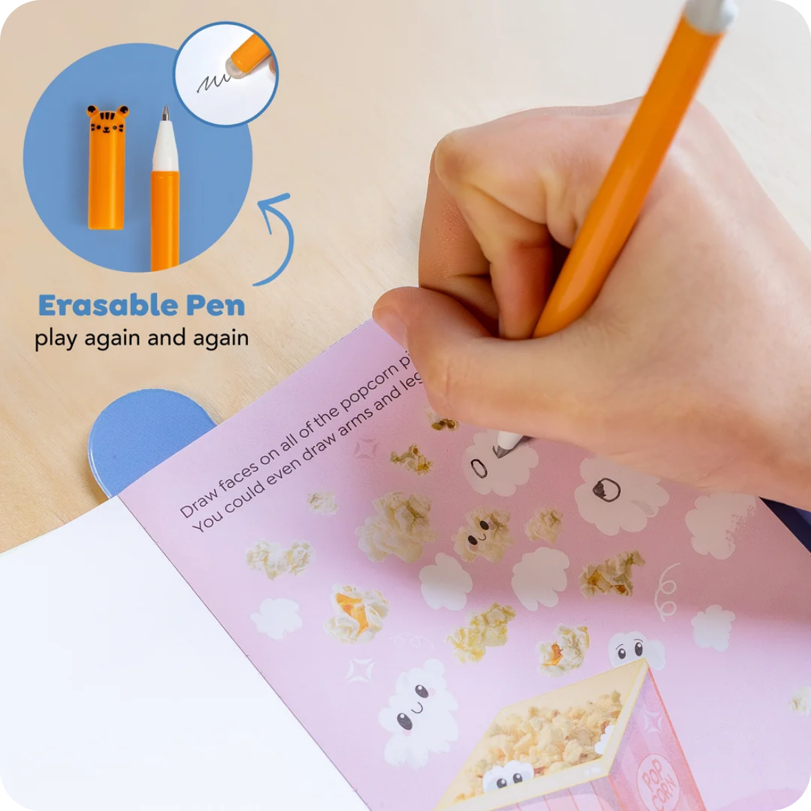 A hand holds an orange erasable pen over a pink drawing pad with cartoon popcorn illustrations. The image includes a circular inset showing the pen's tiger-face end and text reading 'Erasable Pen play again and again.