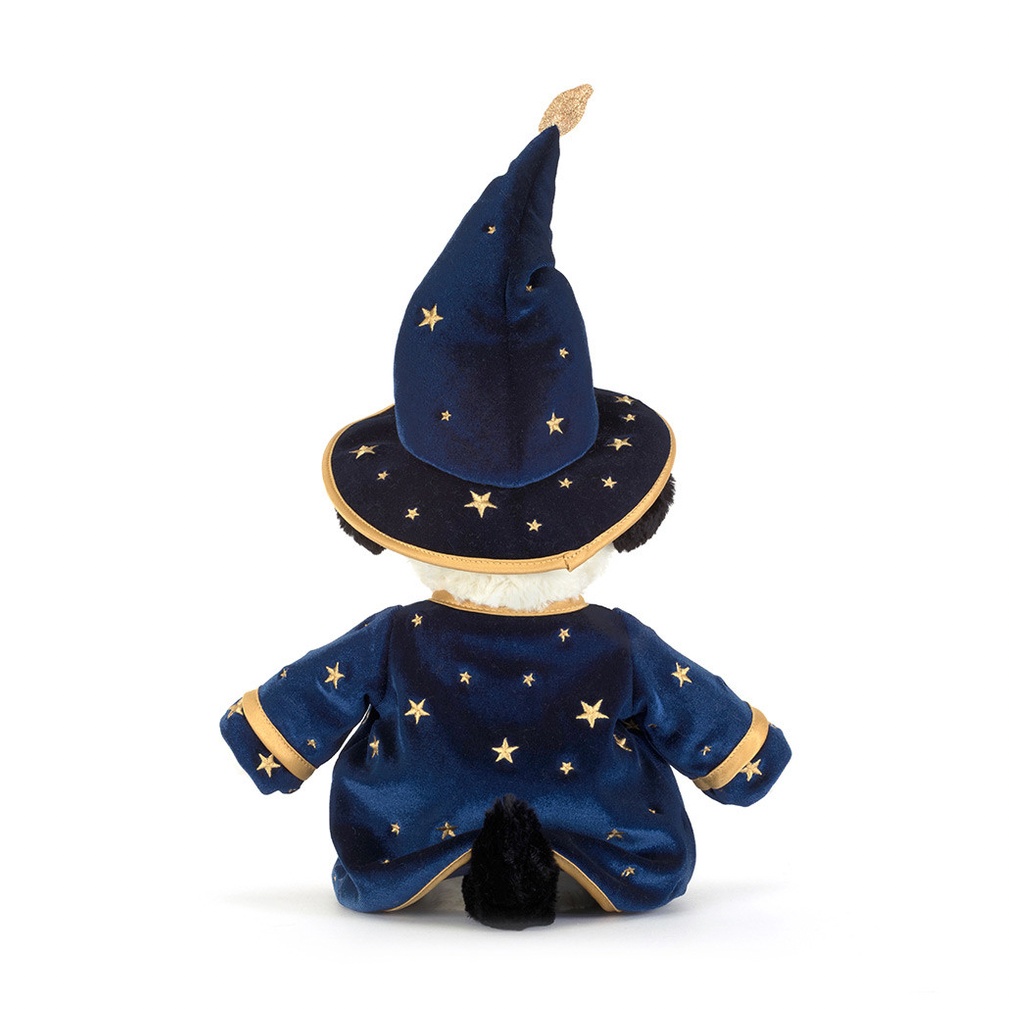 A plush puppy toy shown from the back wearing a wizard costume, with a tall navy blue hat and matching robe decorated with gold stars and trim, on a white background with product text below.