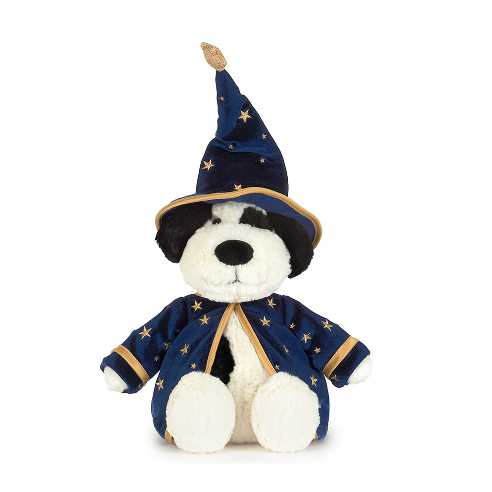 A plush dog toy dressed as a wizard, wearing a navy blue pointed hat and matching robe with gold star patterns and trim, set against a plain white background.