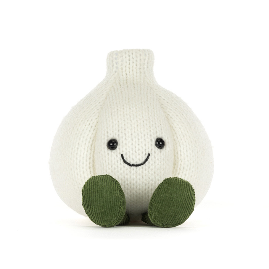 A knitted garlic plush toy with a smiling face and green feet, photographed against a solid white background.