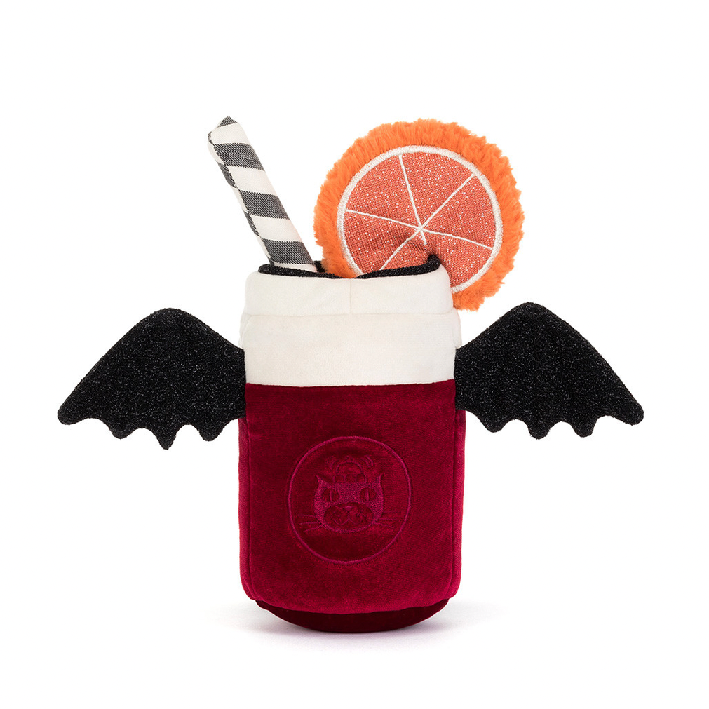 A plush vampire cocktail cup toy with black bat wings, a deep red body, a white foam top, a black-and-white striped straw, and an orange slice garnish, shown on a plain white background.