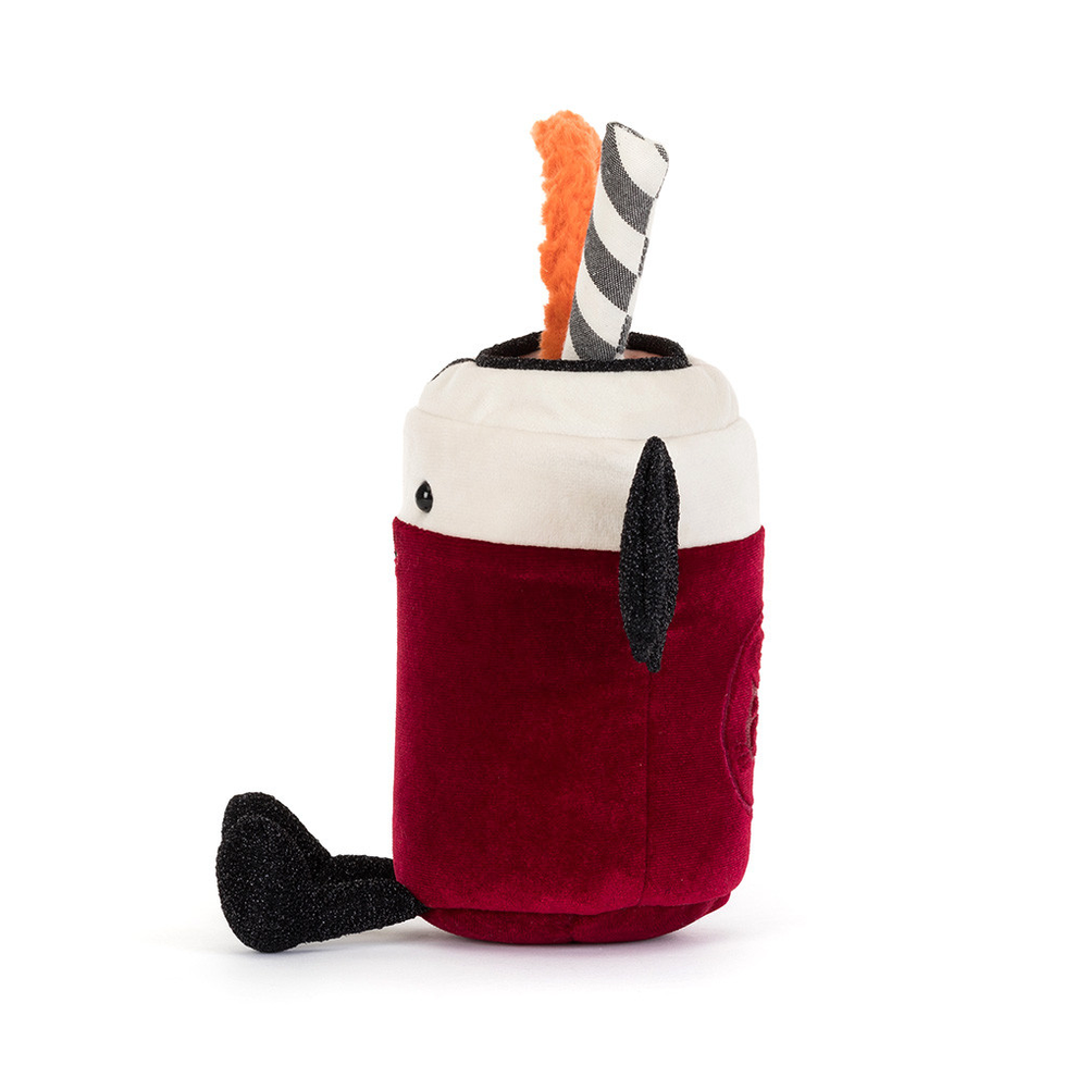 A plush dog toy shaped like a hot dog in a bun, featuring a deep red body, a white top bun, black ears and paws, with an orange bone and a black-and-white striped stick sticking out of the top, photographed on a solid white background.