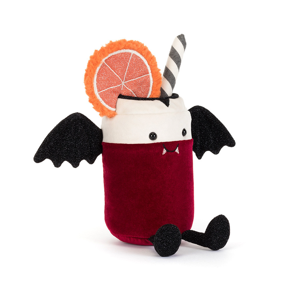 A plush vampire cocktail toy featuring a deep red body, a white cup rim, black wings and feet, a black-and-white striped straw, and an orange slice garnish on a plain white background.