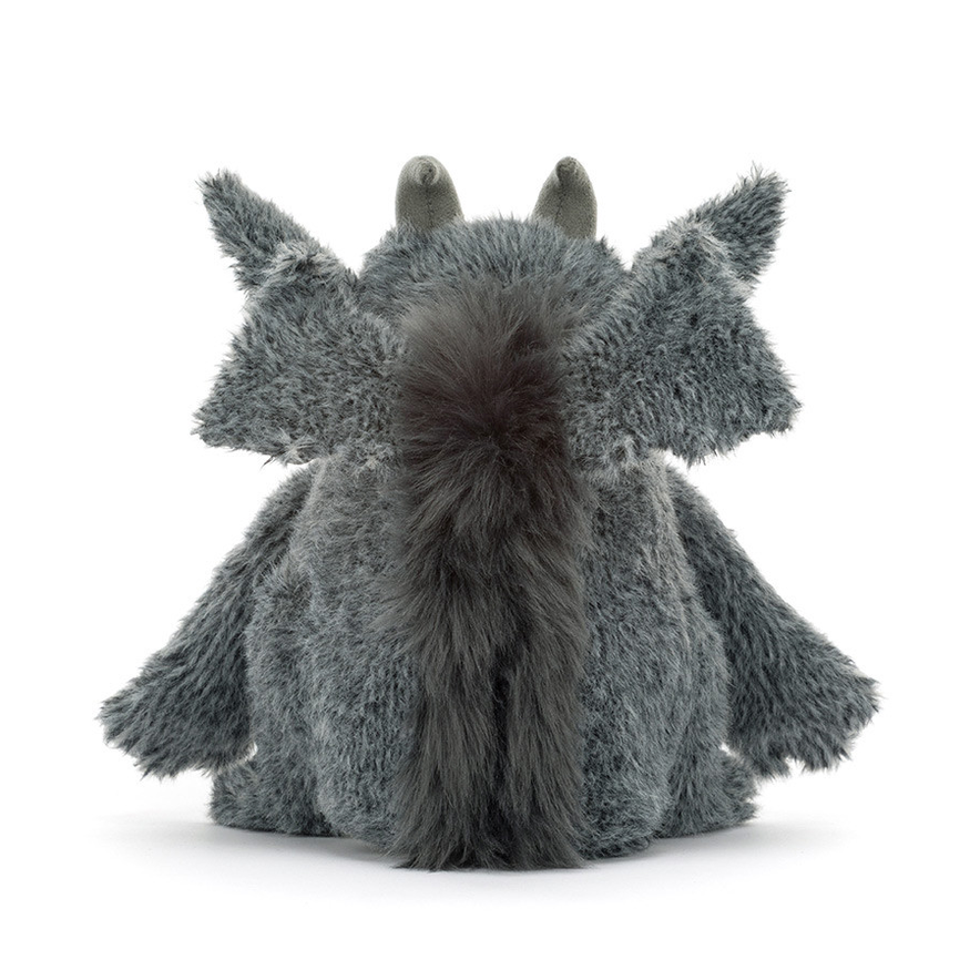 A gray plush dragon toy shown from the back, featuring fluffy textured fur, small pointed ears, and a darker gray tail, photographed on a clean white background.