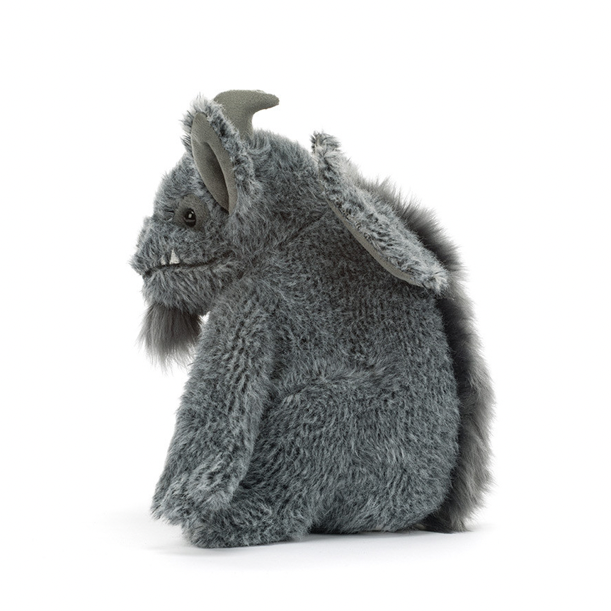 A gray plush monster toy with small horns, textured fur, and a fluffy tail, photographed on a clean white background.
