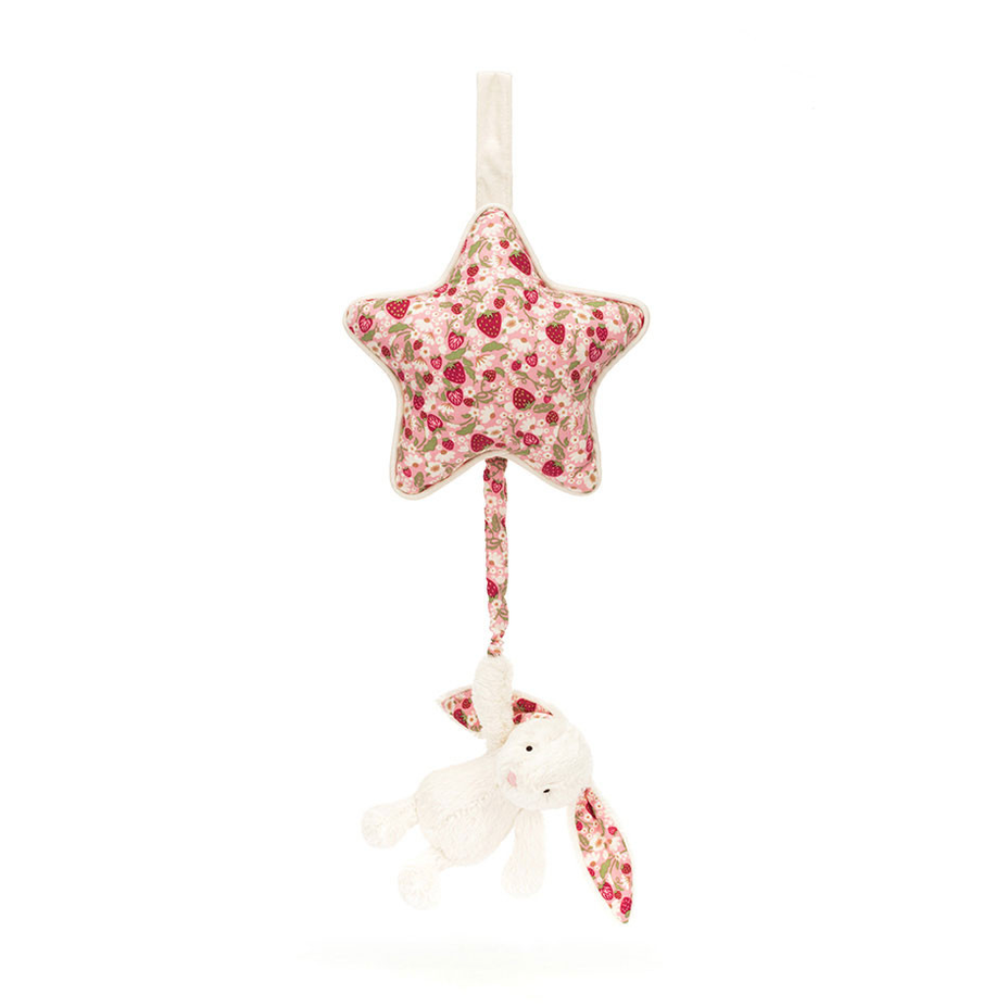 A fabric baby mobile featuring a star-shaped plush toy and a small stuffed bunny, both in a red and white floral print on an off-white background, hanging from a white ribbon.