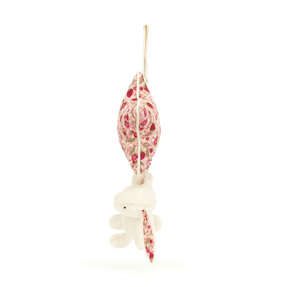 A delicate hanging ornament featuring a small white plush bunny with  pink and white patterned ears, suspended below a matching pink and white patterned star.