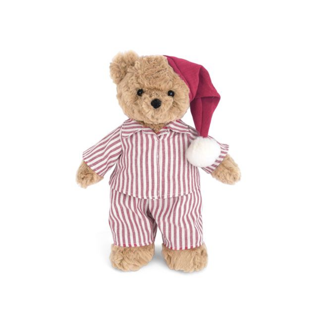 A plush teddy bear wearing red and white striped pajamas and a red Santa hat with a white pom-pom, standing against a plain white background.