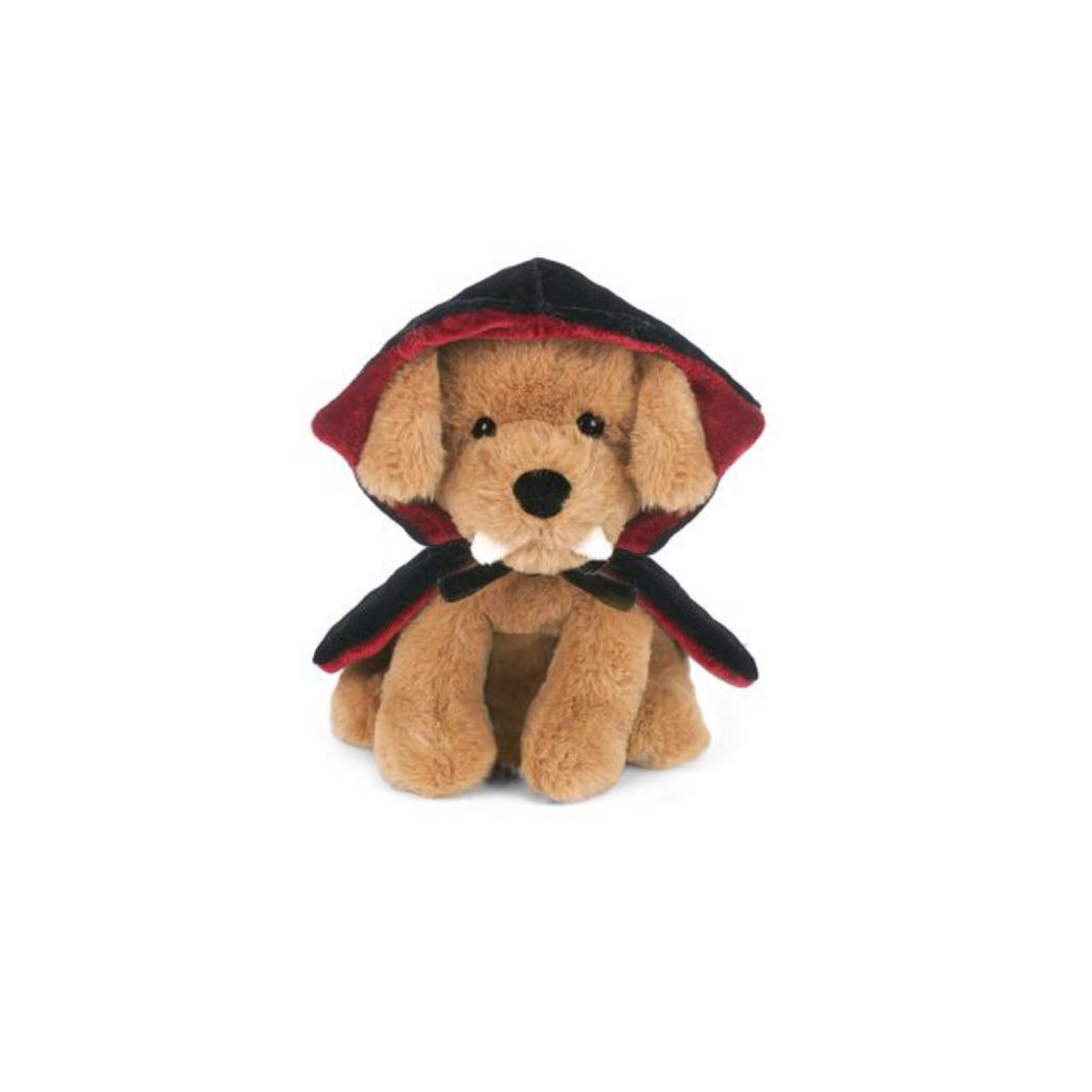 Plush toy dog with fangs and a red and black cape on a white background