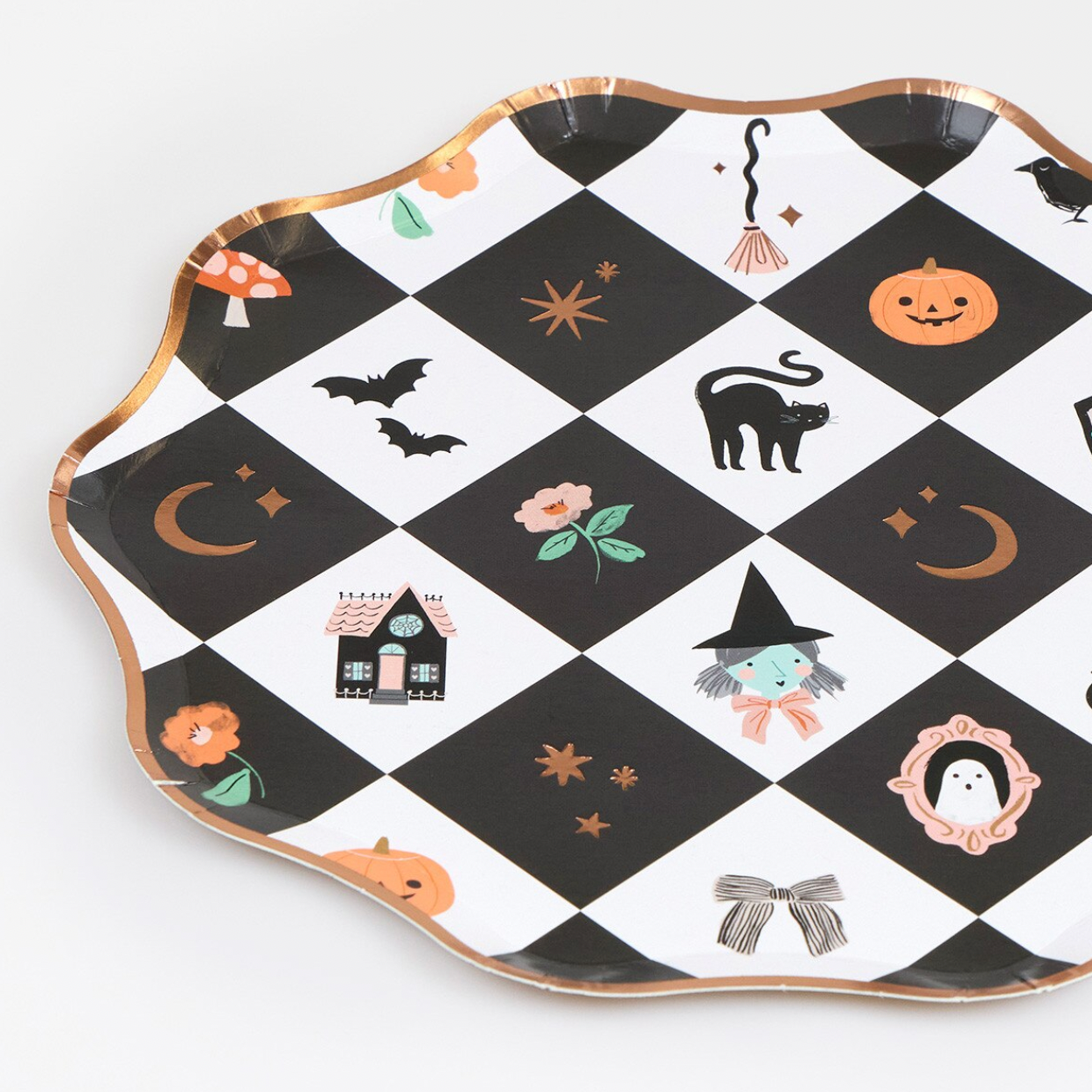A scalloped Halloween-themed serving tray with a black and white diamond pattern, featuring illustrations of pumpkins, bats, a witch, a ghost, a house, and gold-rimmed edges, shown on a light background.