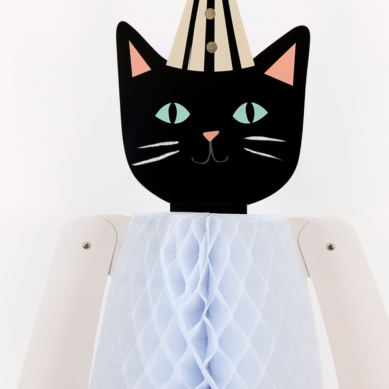 A stylized black cat head with mint green eyes and pink inner ears mounted on a cream-colored robot or doll torso with a white honeycomb-patterned bib or front panel, photographed against a plain white background.