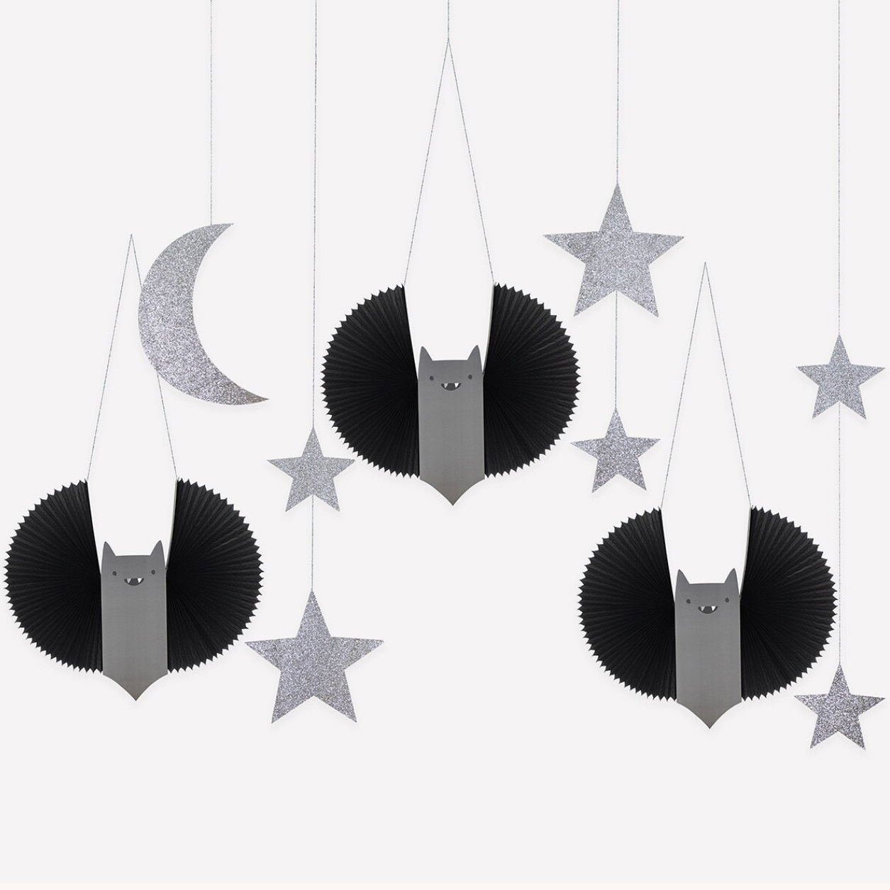 Three hanging bat decorations with black and gray bodies and silver glitter stars and a silver crescent moon on a white background.