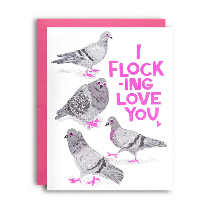 A greeting card featuring four illustrated pigeons in gray and black with bright pink accents, next to a pink envelope. The card reads 'I FLOCKING LOVE YOU' in pink text on a white background.