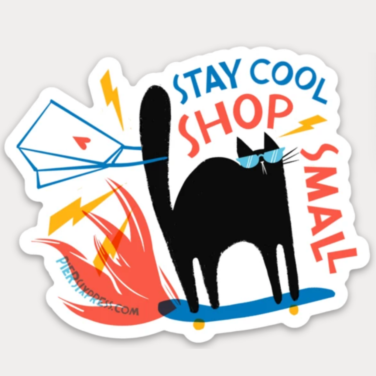 A die-cut sticker featuring a black cat on a skateboard with the text 'STAY COOL SHOP SMALL' in blue and red, plus orange flames and a blue skateboard
