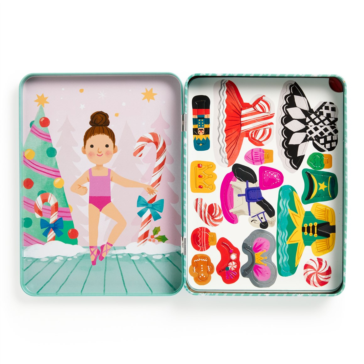 A children's wooden craft kit in a square metal tin, shown open to reveal a decorated winter scene on the left panel and assorted colorful wooden craft pieces on the right panel.
