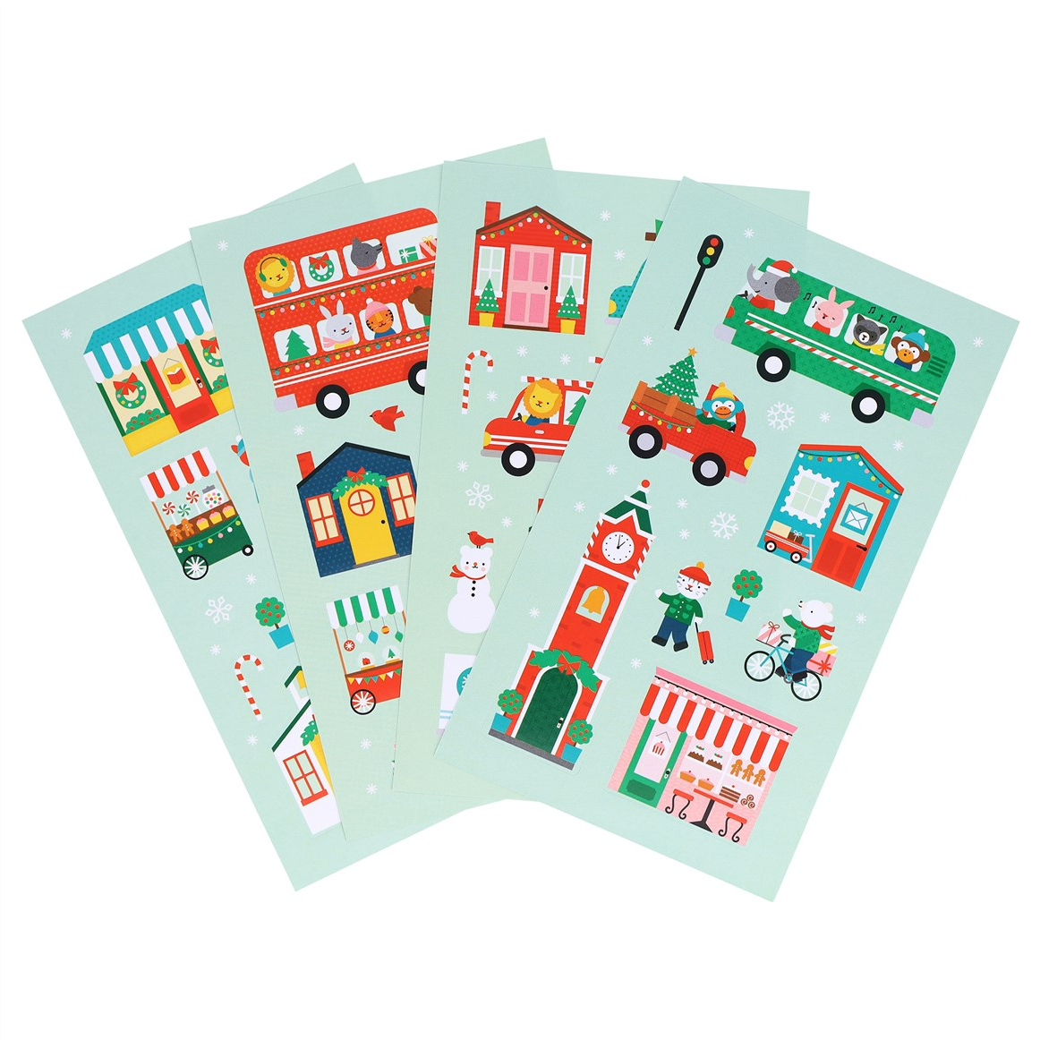 Four sheets of Christmas-themed stickers fanned out on a white background, featuring festive illustrations like red buses, a clock tower, a snowman, and holiday storefronts on a pale mint green base.