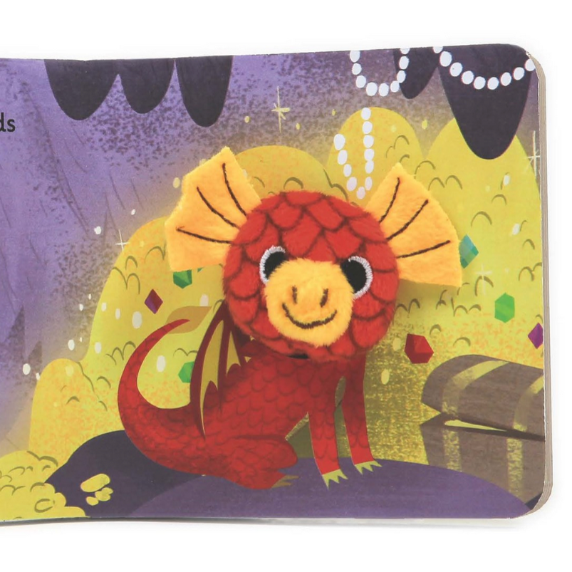 A children's book or board book featuring a colorful dragon illustration on the cover. The cover shows a red dragon with yellow wings and a smiling face, set against a purple and yellow illustrated background with small cutout tabs visible along the left edge.