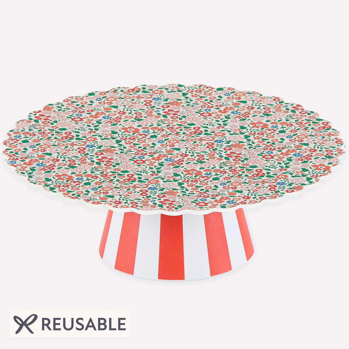 A reusable round table top with a scalloped edge, featuring a multicolor floral pattern on top and a white and red striped pedestal base, shown on a light gray background with a 'REUSABLE' badge.