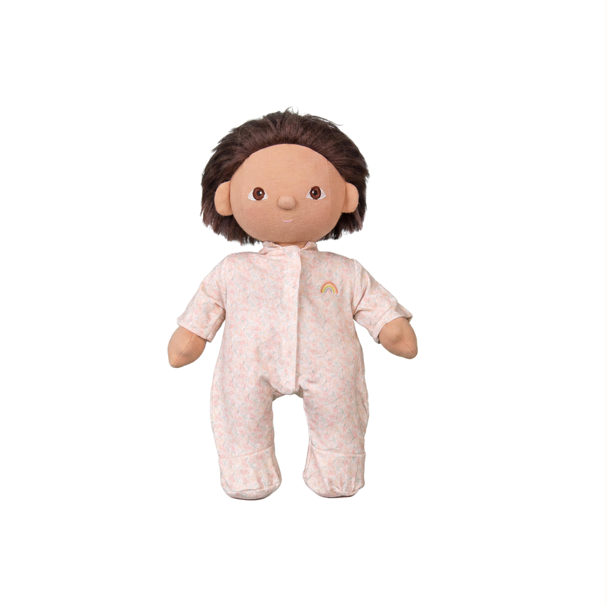 Plush baby doll with brown hair wearing a light pink onesie on a white background
