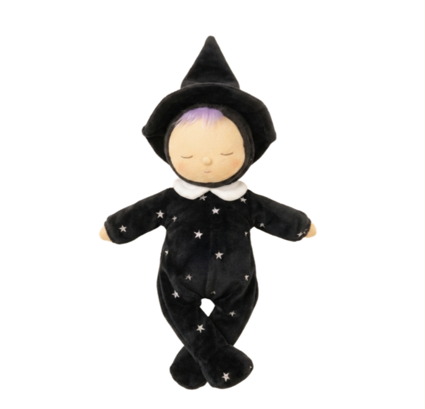 A plush baby doll wearing a black witch costume with white embroidered stars, a white collar, and a black pointed hat, shown against a plain white background.