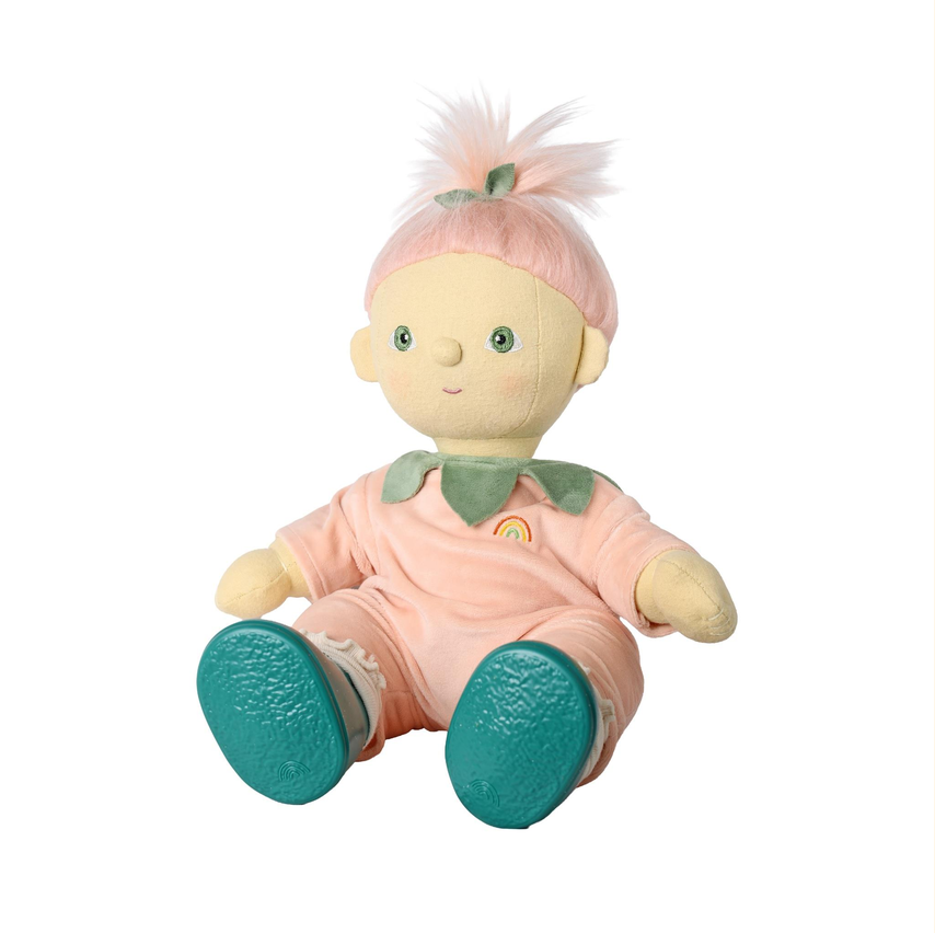 A plush doll with pale yellow skin, pink hair, and a pink outfit with green accents and teal shoes, shown against a plain white background.