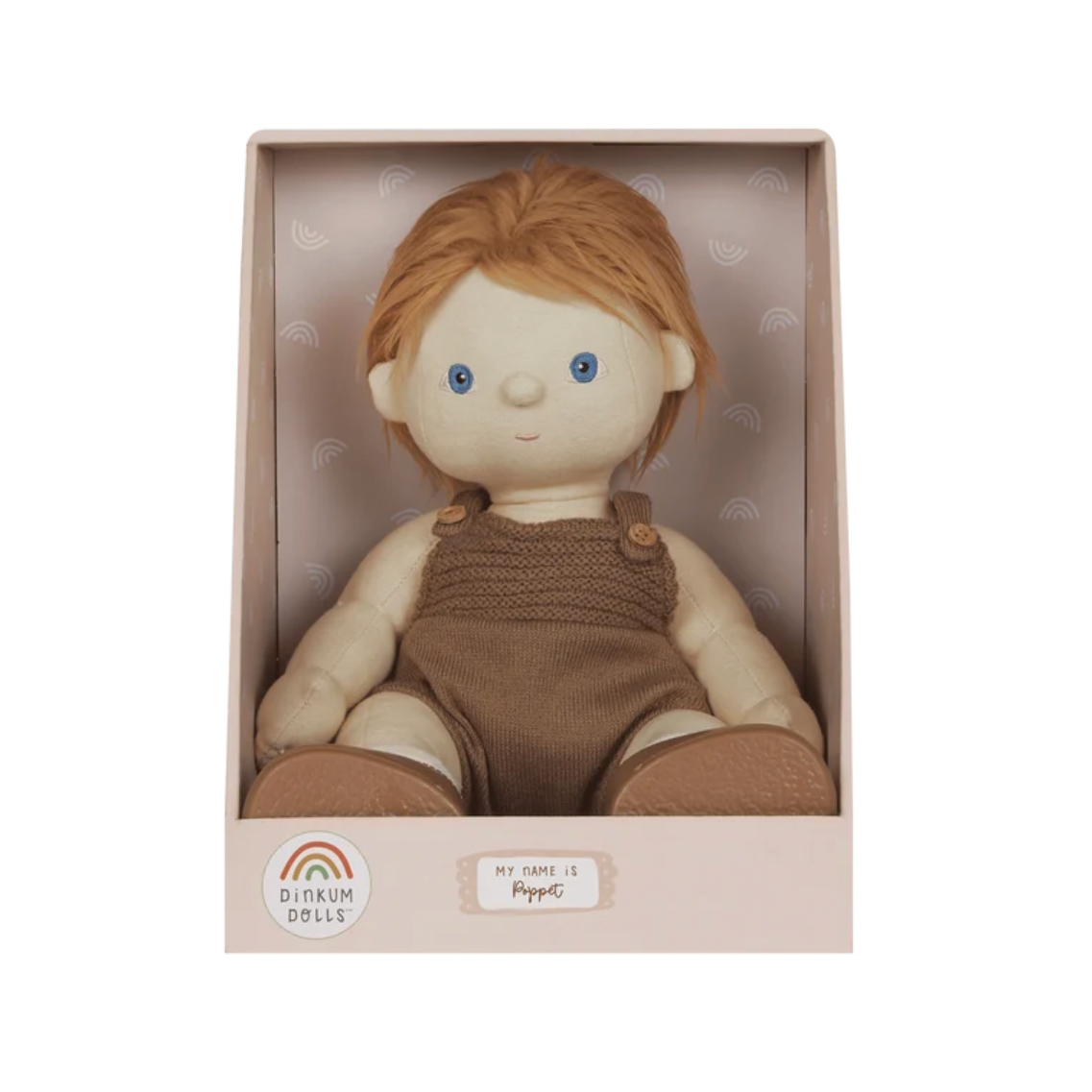 A Dinkum Dolls 'Pippa' cloth doll with red hair and blue eyes, wearing a brown knit romper, presented inside its original light pink packaging box.