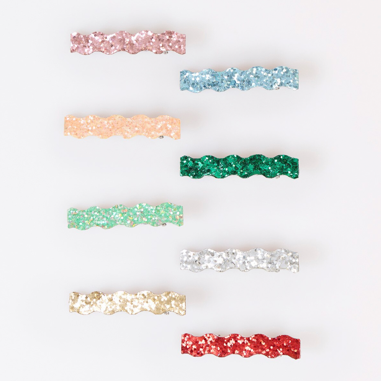 Six glittery wavy hair claw clips in assorted colors, including pink, light blue, peach, green, white, and red, arranged vertically on a white background.