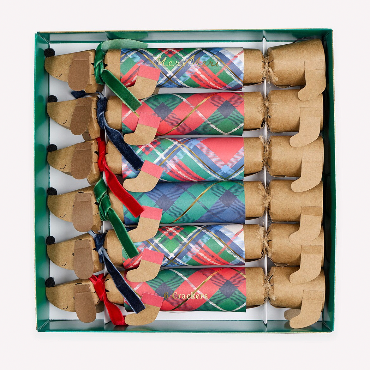 A boxed set of eight dog toys arranged in a green tray. Each toy is shaped like a dog's front leg with a brown cardboard boot-like body and a colorful plaid fabric upper section.