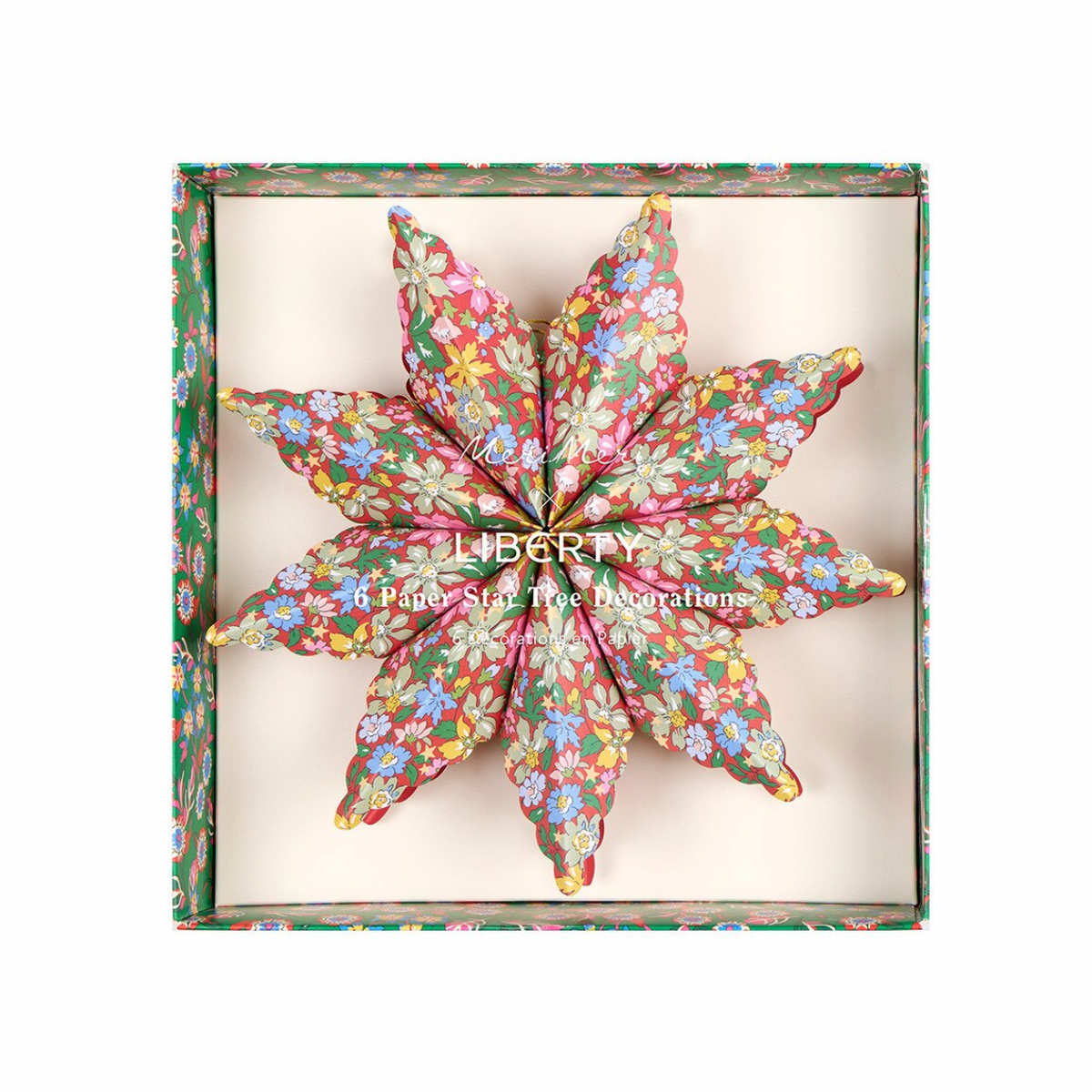An eight-pointed star-shaped decorative pillow with a colorful floral print, presented inside its matching floral-patterned gift box. The brand name 'LIBERTY' is printed on the front of the box.