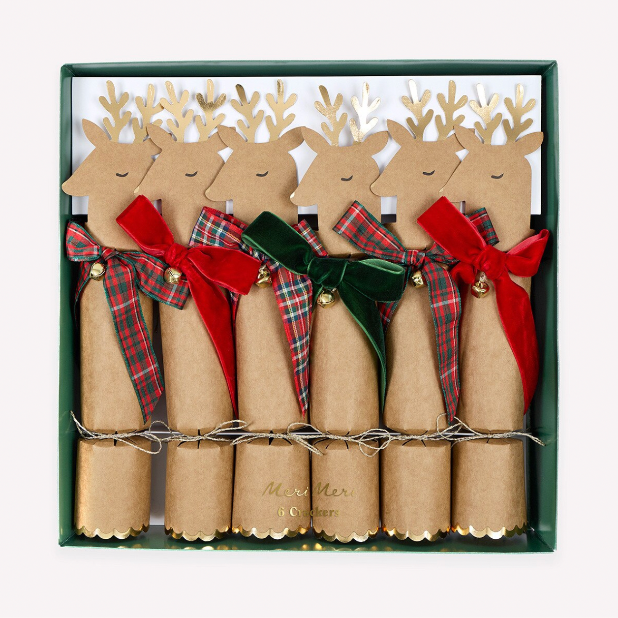A set of six Christmas cracker packs in a dark green box, decorated with cardboard reindeer heads, gold antlers, brown paper bodies, and ribbon bows in red, green, and plaid.