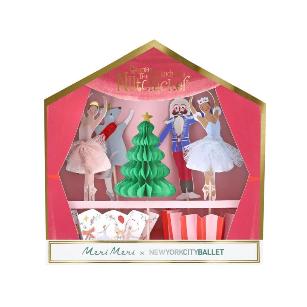 A house-shaped gift box featuring a Nutcracker-themed ballet display with paper ballerinas, a nutcracker figure, a green Christmas tree, and holiday cards. The box has gold trim and a bottom label reading 'Meri Meri x NEWYORKCITYBallet'.
