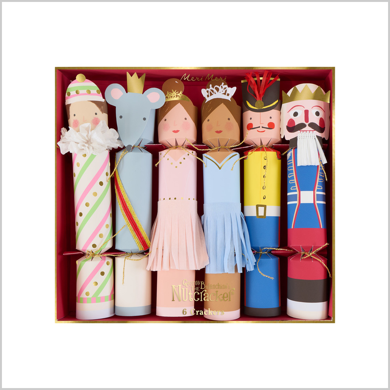 A boxed set of six Christmas crackers shaped like fairy tales characters, including a prince, princess, mouse, nutcracker, and dwarfs, arranged in a red gift box against a white background.