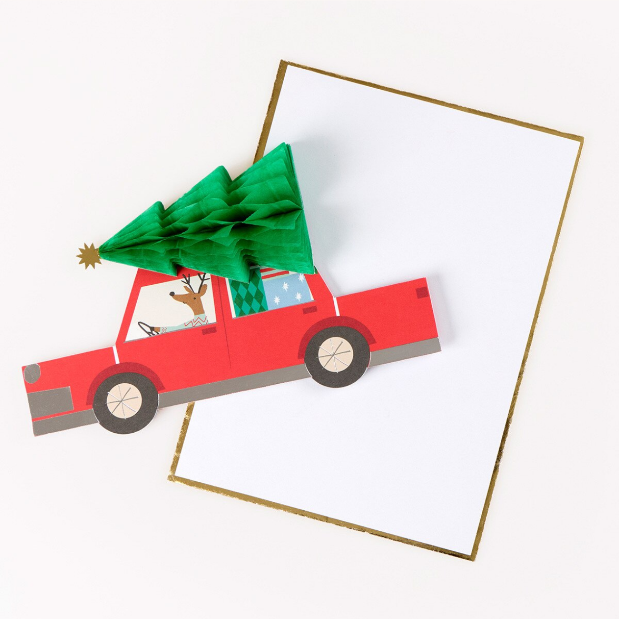 A red pop-up truck card with a green 3D Christmas tree on its roof, shown on top of a white card with a gold border against a light background.