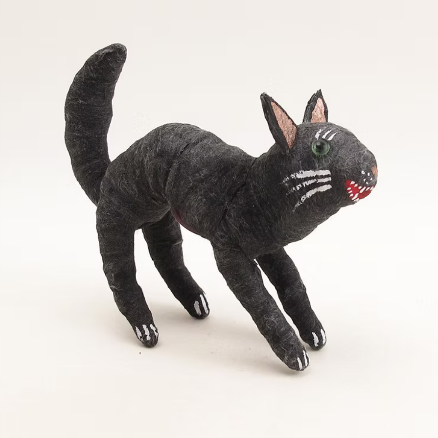 A handmade black cat figurine with textured fabric, white whiskers, pink inner ears, and a small red mouth, standing on a white background.