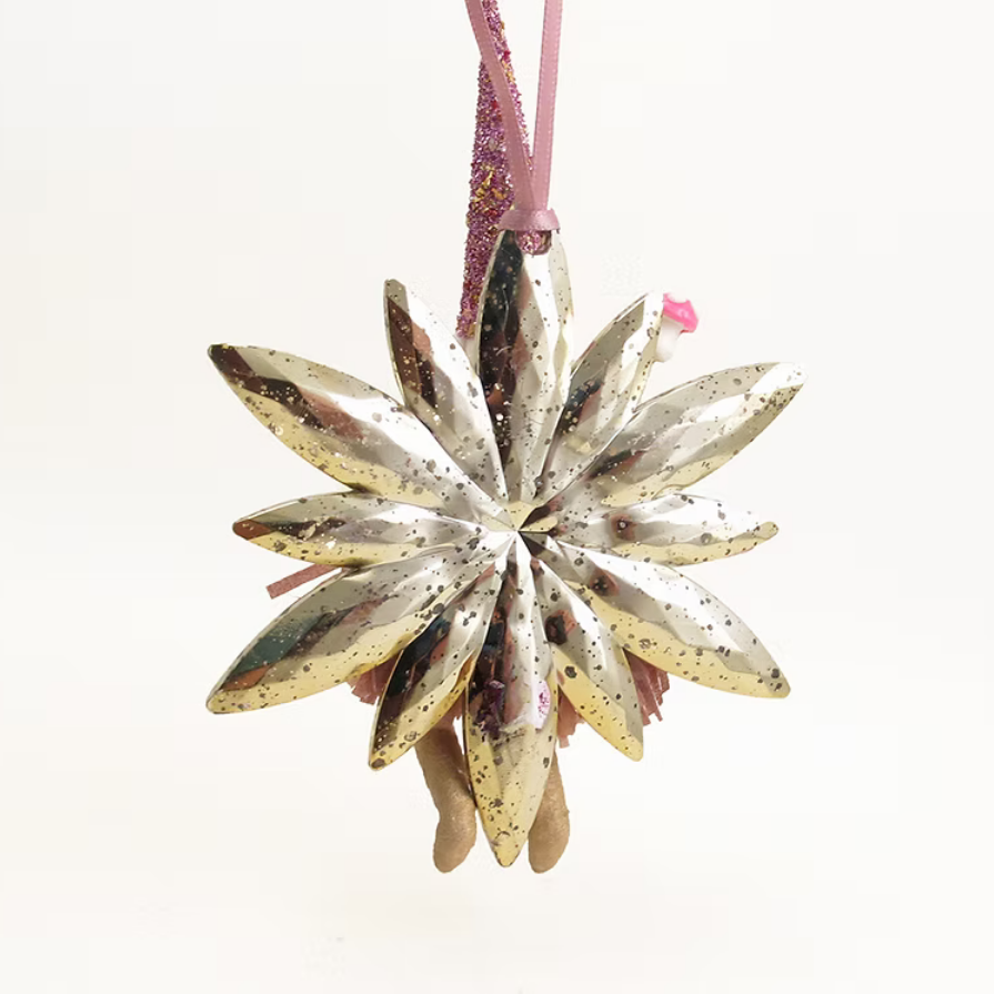 A metallic gold star-shaped Christmas ornament with a pink hanging ribbon, shown against a plain white background.