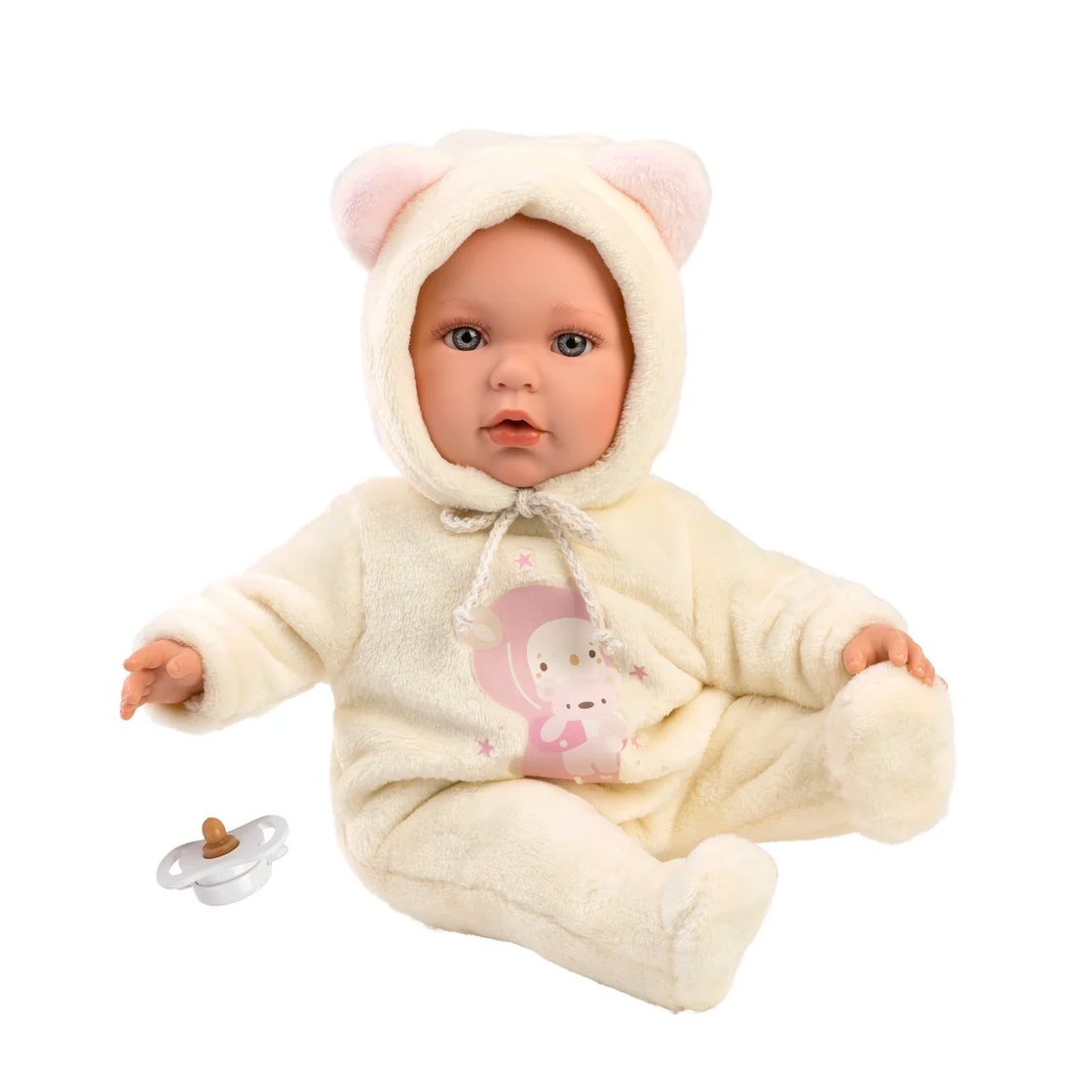 A realistic baby doll wearing a cream-colored hooded onesie with pink bear ears and a pink bunny graphic on the chest, shown on a white background with a pacifier nearby.