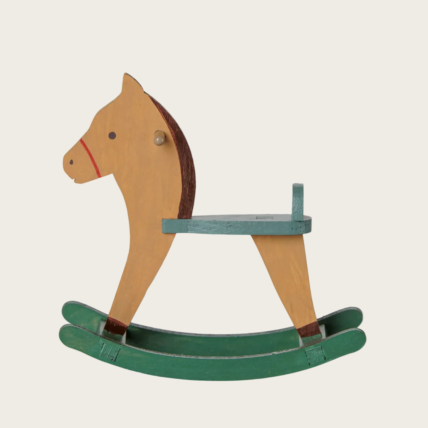A wooden rocking horse with a light tan body, dark brown mane and legs, and a muted green seat and rockers.