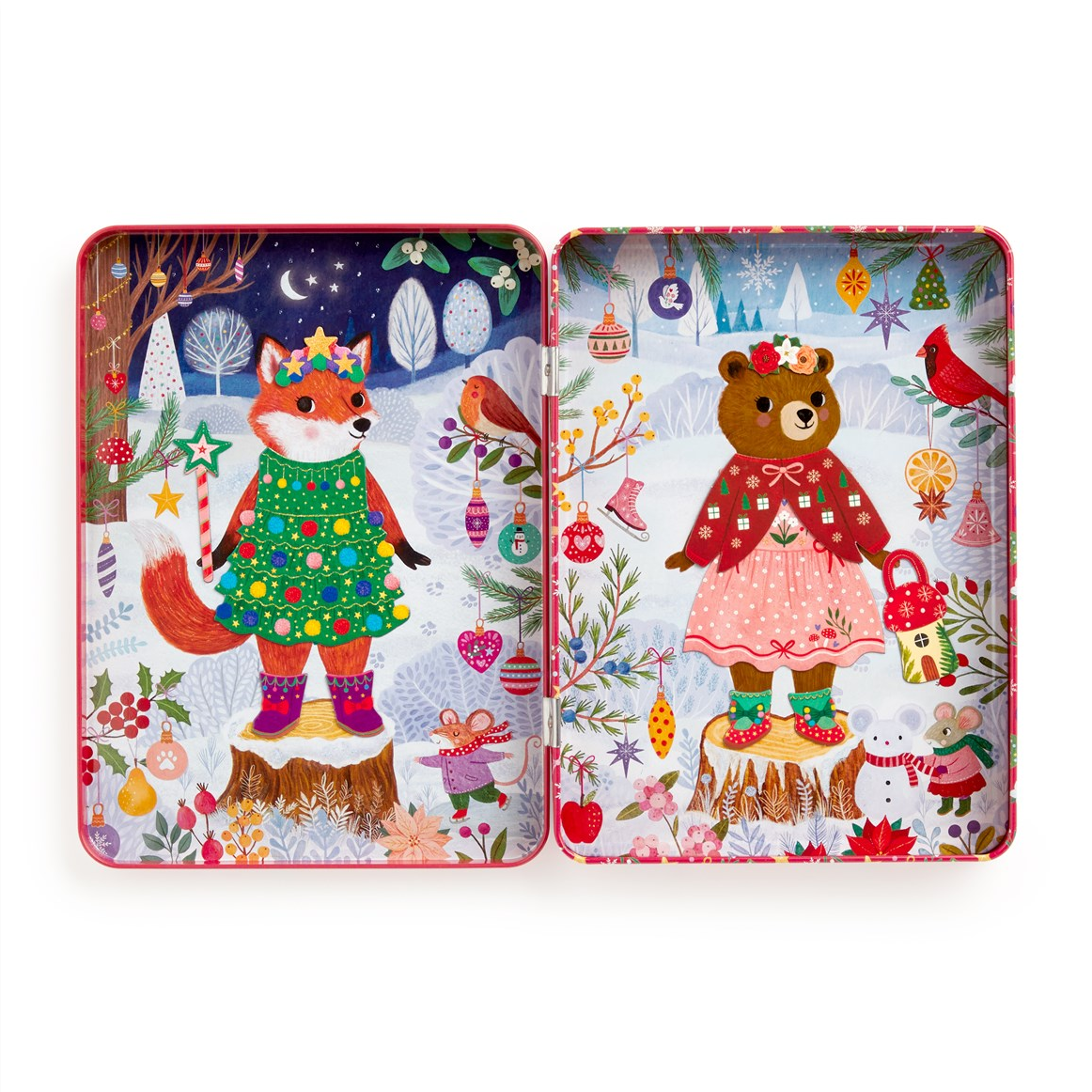 A square tin with illustrated Christmas scenes, shown open to reveal two decorated panels. The left panel shows a fox in a green Christmas tree dress standing on a stump in a snowy forest.
