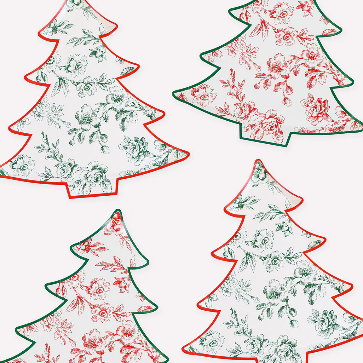 Four Christmas tree-shaped decorative cutouts or labels arranged on a white background, each with a floral toile-style print and contrasting tree outline in red or green.