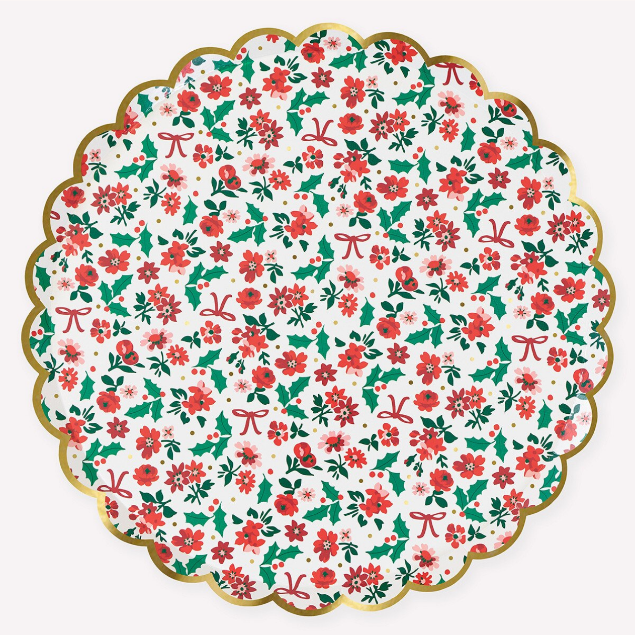 A scalloped paper plate featuring a festive Christmas floral pattern with red flowers, green holly leaves, red bows, and a metallic gold border on a white background.