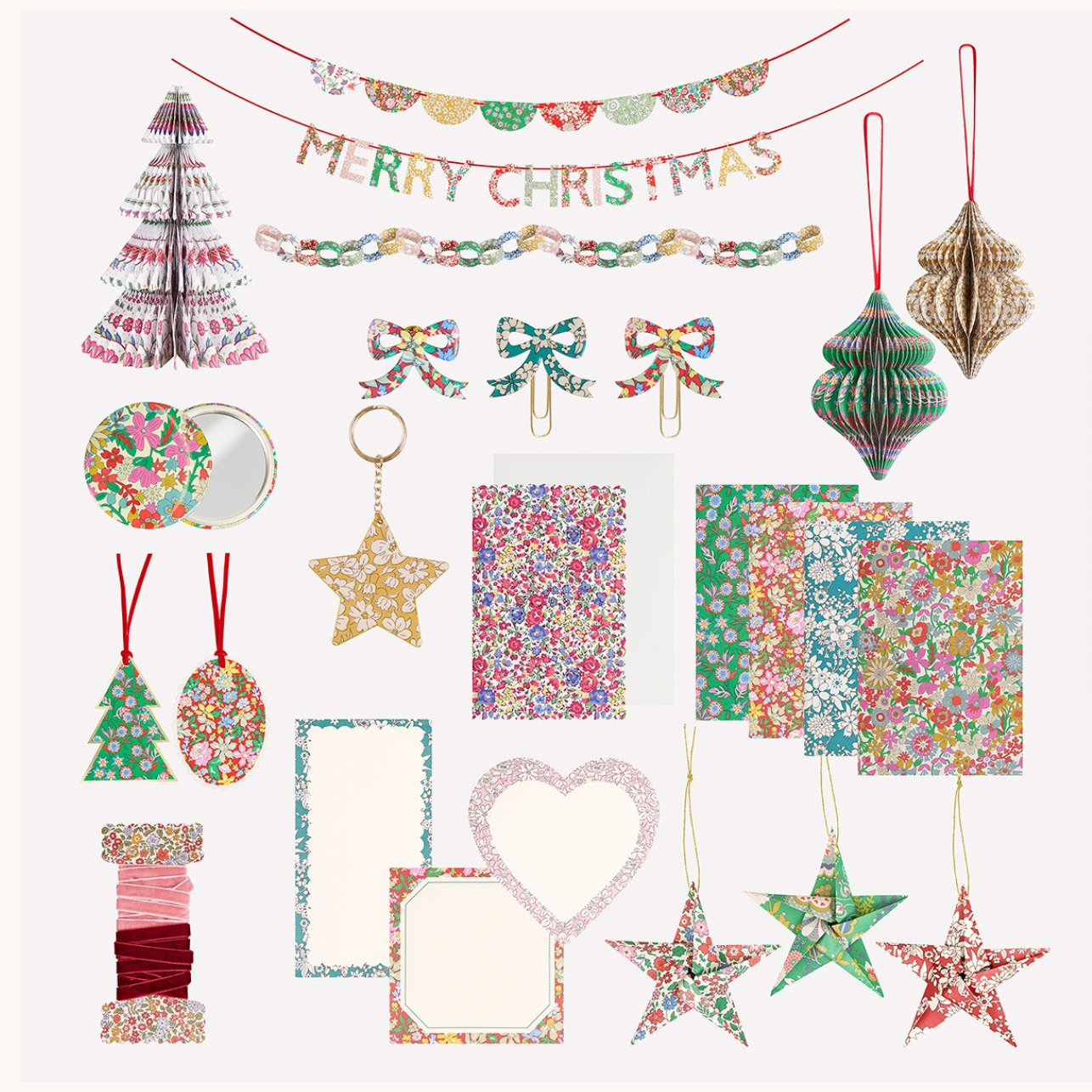 A coordinated Christmas craft or party decoration set arranged on a white background, including a 'Merry Christmas' banner, hanging ornaments, patterned paper garlands, bow clips, star and tree ornaments, and decorative paper elements.