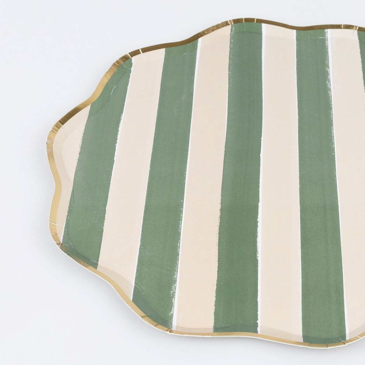 A scalloped serving plate with vertical stripes in sage green and cream, finished with a metallic gold rim, shown on a light gray background.