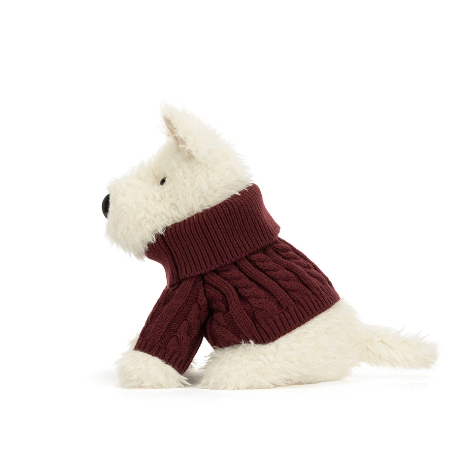 A plush dog toy wearing a burgundy cable-knit turtleneck sweater, photographed from the side against a clean white background.