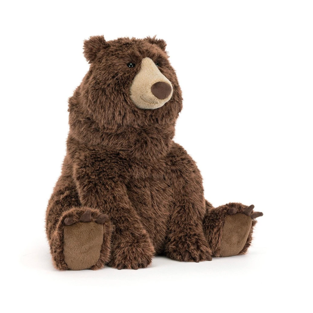 A plush stuffed bear toy in dark brown with a cream-colored snout and nose, sitting against a plain white background.
