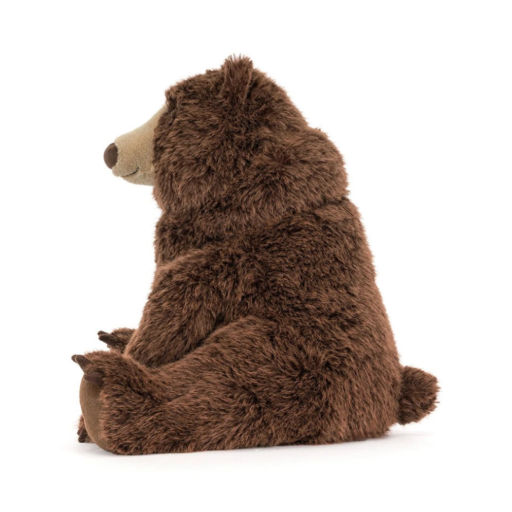 A plush brown bear toy shown from the back, sitting down, on a clean white background.