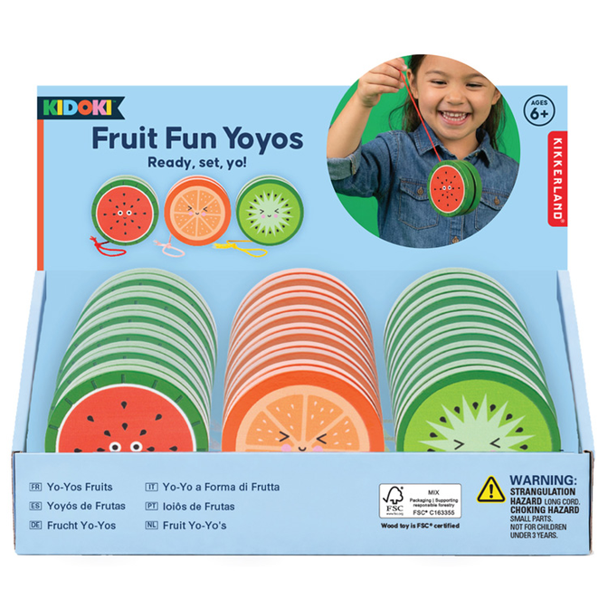 Kidoki Fruit Fun Yoyos toy set in its original retail packaging, featuring three stacks of fruit-themed wooden yo-yos (watermelon, orange, kiwi) inside a light blue box with a circular inset photo of a child playing.