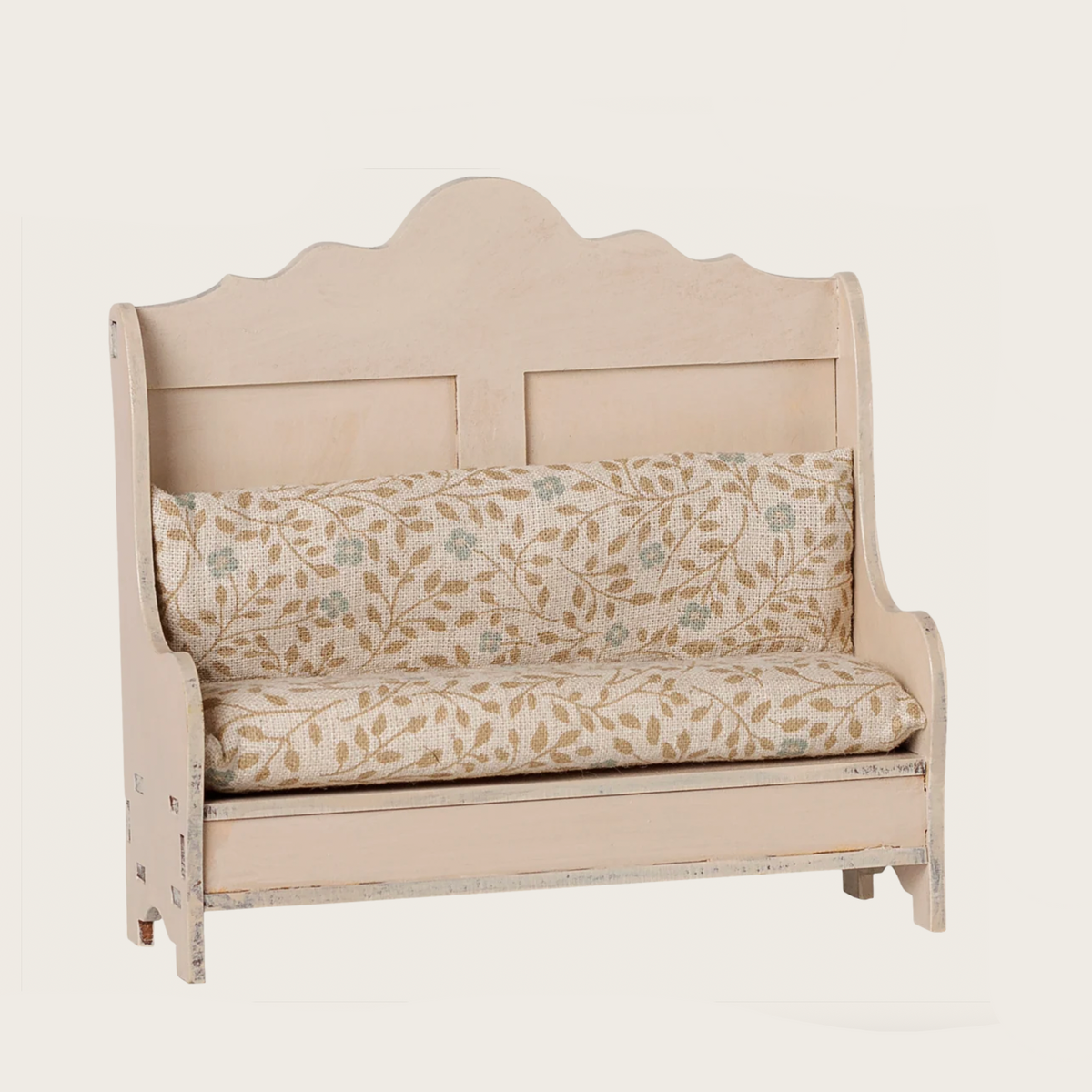 A light wood bench-style sofa with a cream floral upholstered seat and back cushion, shown on a plain light background. 