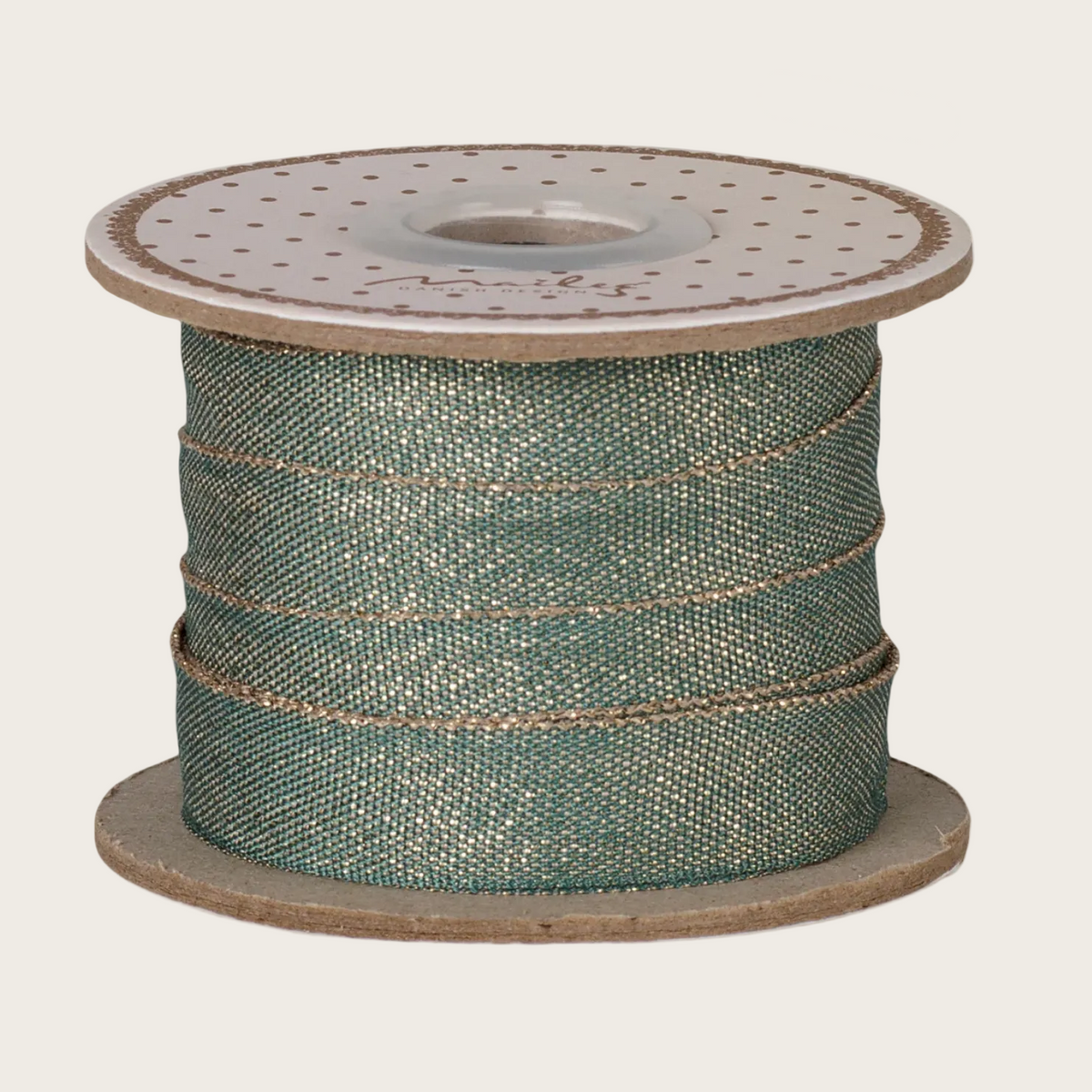 A spool of green woven ribbon or cord shown on a webpage, with the Maileg logo visible at the top of the page. The product appears mounted on a spool with a beige background around it.